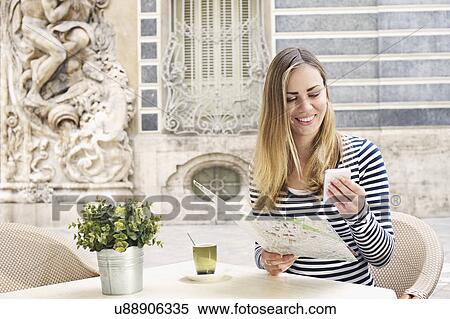 Young woman looking at smartphone outside Museum of Ceramics, Valencia, Spain View Large Photo Image Stock Photography - Young woman looking at smartphone outside Museum of Ceramics, Valencia, Spain. Fotosearch