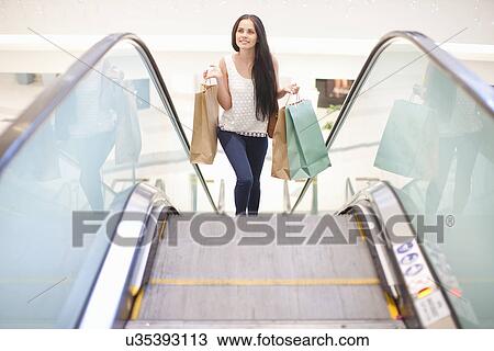 Stock Image - Young woman on shopping spree. Fotosearch