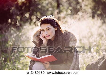 Young woman reading in the woods View Large Photo Image Stock Image - Young woman reading in the woods. Fotosearch