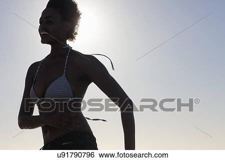 Young woman running in bikini View Large Photo Image Stock Photograph - Young woman running in bikini. Fotosearch
