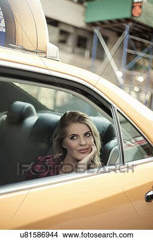 Young woman sightseeing from yellow cab, New York City, USA View Large Photo Image Picture - Young woman sightseeing from yellow cab, New York City, USA. Fotosearch