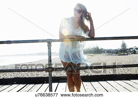 Young woman standing on pier, Melbourne, Victoria, Australia View Large Photo Image Stock Photo - Young woman standing on pier, Melbourne, Victoria, Australia. Fotosearch