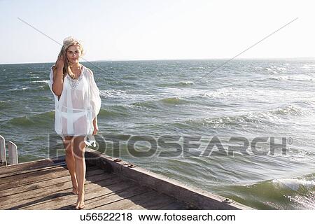 Young woman strolling on pier, Melbourne, Victoria, Australia View Large Photo Image Stock Photo - Young woman strolling on pier, Melbourne, Victoria, Australia. Fotosearch