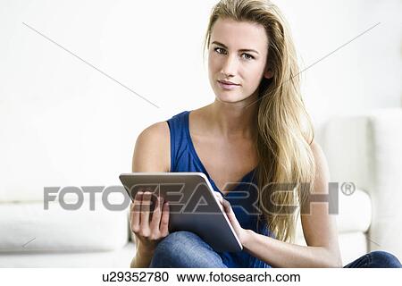 Young woman using digital tablet View Large Photo Image Stock Image - Young woman using digital tablet. Fotosearch