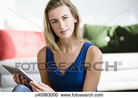 Young woman using digital tablet View Large Photo Image Stock Image - Young woman using digital tablet. Fotosearch