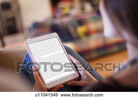 Stock Photo - Young woman using digital tablet. Fotosearch