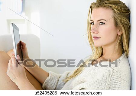 Young woman using digital tablet View Large Photo Image Stock Photography - Young woman using digital tablet. Fotosearch
