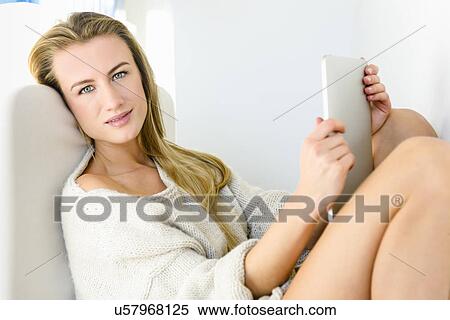 Stock Photography - Young woman using digital tablet. Fotosearch