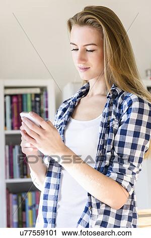 Young woman using smartphone View Large Photo Image Stock Image - Young woman using smartphone. Fotosearch