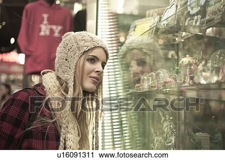 Young woman window shopping, New York City, USA View Large Photo Image Stock Image - Young woman window shopping, New York City, USA. Fotosearch