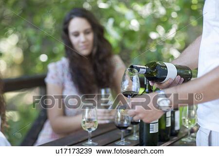 Stock Photo - Young woman wine tasting at vineyard. Fotosearch