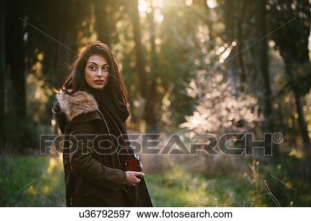 Young woman with camera in the woods View Large Photo Image Stock Photo - Young woman with camera in the woods. Fotosearch