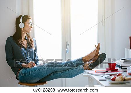 Young woman with headphones View Large Photo Image Stock Photo - Young woman with headphones. Fotosearch