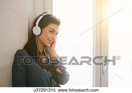 Young woman with headphones View Large Photo Image Stock Photography - Young woman with headphones. Fotosearch