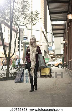Young woman with shopping bags, New York City, USA View Large Photo Image Stock Image - Young woman with shopping bags, New York City, USA. Fotosearch
