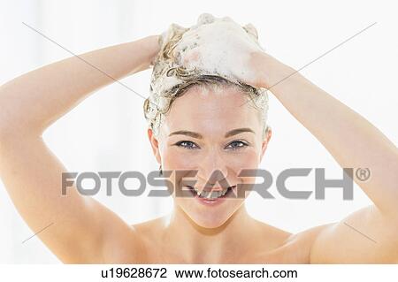 Stock Image - Beautiful woman washing hair. Fotosearch