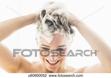 Stock Image - Beautiful woman washing hair. Fotosearch