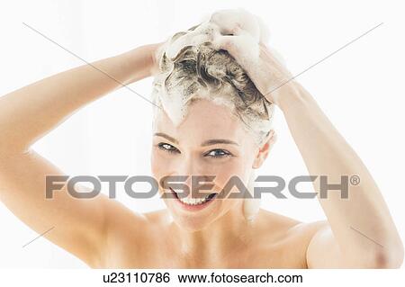 Stock Photograph - Beautiful woman washing hair. Fotosearch