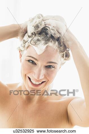 Stock Photography - Beautiful woman washing hair. Fotosearch