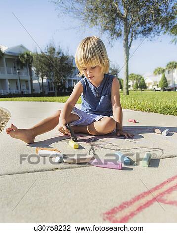 Stock Image - Boy (4-5) playing on playground. Fotosearch