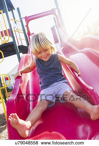 Stock Photo - Boy (4-5) playing on playground. Fotosearch
