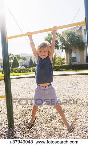 Boy (4-5) playing on playground View Large Photo Image Stock Photo - Boy (4-5) playing on playground. Fotosearch