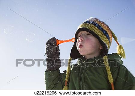 Boy (4-5) playing with bubbles View Large Photo Image Stock Photograph - Boy (4-5) playing with bubbles. Fotosearch