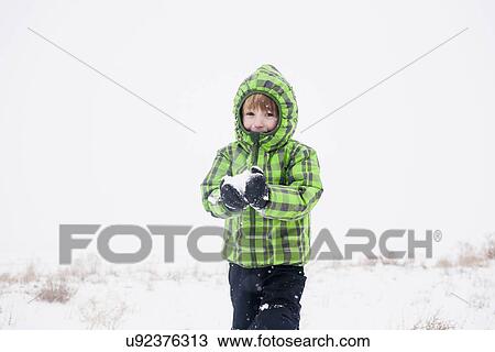 Boy (4-5) playing with snow View Large Photo Image Stock Image - Boy (4-5) playing with snow. Fotosearch