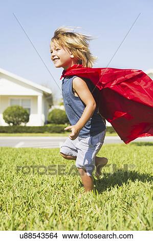 Boy (4-5) running with cape View Large Photo Image Picture - Boy (4-5) running with cape. Fotosearch