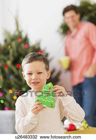 Boy (6-7) holding gingerbread View Large Photo Image Stock Image - Boy (6-7) holding gingerbread. Fotosearch