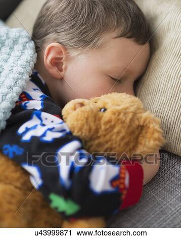 Boy (6-7) holding teddy bear during sleep View Large Photo Image Stock Image - Boy (6-7) holding teddy bear during sleep. Fotosearch