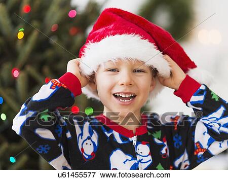 Boy (6-7) wearing santa hat View Large Photo Image Stock Photo - Boy (6-7) wearing santa hat. Fotosearch