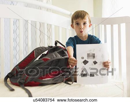 Boy (8-9) showing his homework View Large Photo Image Picture - Boy (8-9) showing his homework. Fotosearch