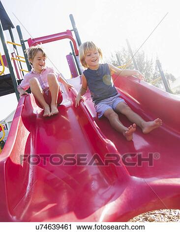 Boys (4-5, 8-9) playing on playground View Large Photo Image Stock Image - Boys (4-5, 8-9) playing on playground. Fotosearch