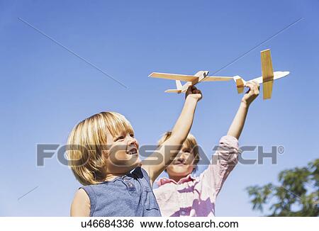 Boys (4-5, 8-9) playing with airplane toys View Large Photo Image Stock Photograph - Boys (4-5, 8-9) playing with airplane toys. Fotosearch