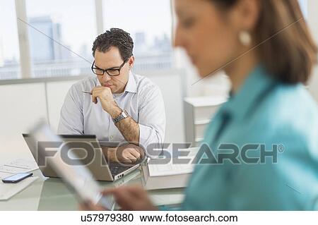 Businessman and businesswoman working in office View Large Photo Image Stock Image - Businessman and businesswoman working in office. Fotosearch