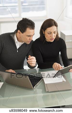 Businessman and businesswoman working in office View Large Photo Image Stock Photo - Businessman and businesswoman working in office. Fotosearch