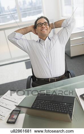 Stock Image - Businessman using laptop and digital tablet. Fotosearch