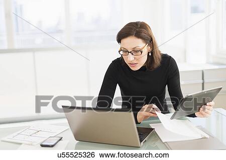 Businesswoman working on laptop and digital tablet View Large Photo Image Stock Photograph - Businesswoman working on laptop and digital tablet. Fotosearch