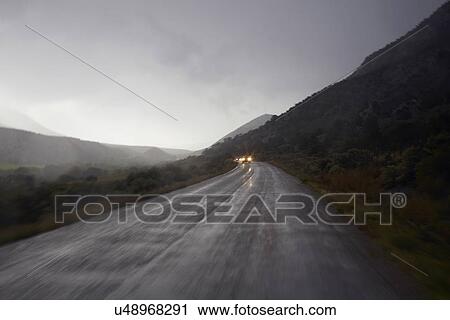 Car lights on wet, foggy, mountain road View Large Photo Image Stock Image - Car lights on wet, foggy, mountain road. Fotosearch