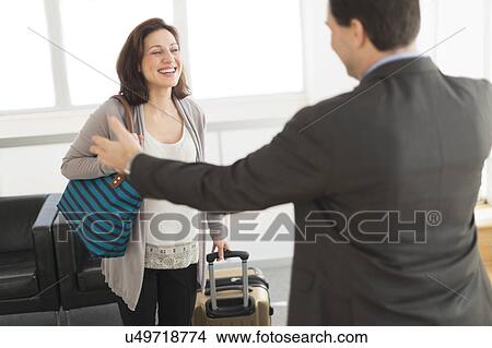 Picture - Couple meeting at airport. Fotosearch