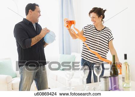 Couple preparing party setting View Large Photo Image Picture - Couple preparing party setting. Fotosearch