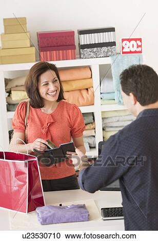 Customer paying in store View Large Photo Image Stock Image - Customer paying in store. Fotosearch
