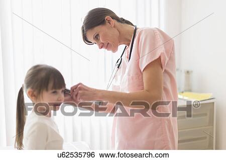 Doctor examining girl (4-5) View Large Photo Image Stock Photograph - Doctor examining girl (4-5). Fotosearch