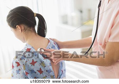 Doctor examining girl (8-9) View Large Photo Image Stock Photo - Doctor examining girl (8-9). Fotosearch