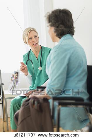 Doctor talking to patient in waiting room View Large Photo Image Stock Photo - Doctor talking to patient in waiting room. Fotosearch