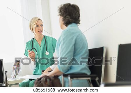 Doctor talking to patient in waiting room View Large Photo Image Stock Photo - Doctor talking to patient in waiting room. Fotosearch