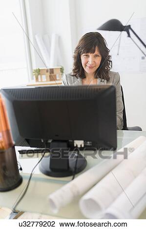 Stock Image - Female business owner at work. Fotosearch