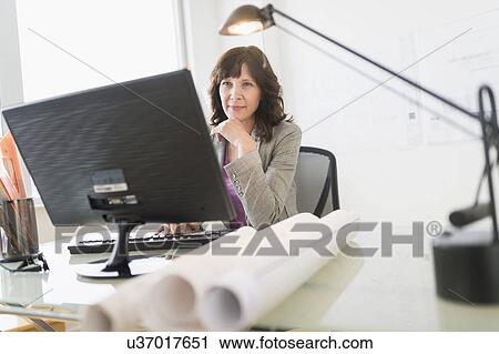 Stock Image - Female business owner at work. Fotosearch