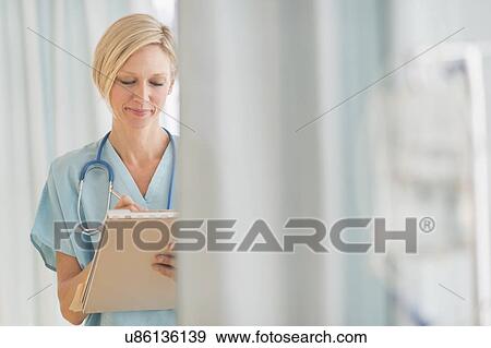Female doctor doing notes View Large Photo Image Stock Photo - Female doctor doing notes. Fotosearch